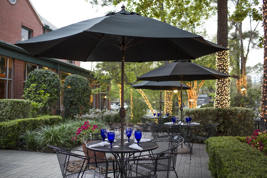 Image of the Amerigo's Grille Patio surrounded by trees decorated with Christmas lights.